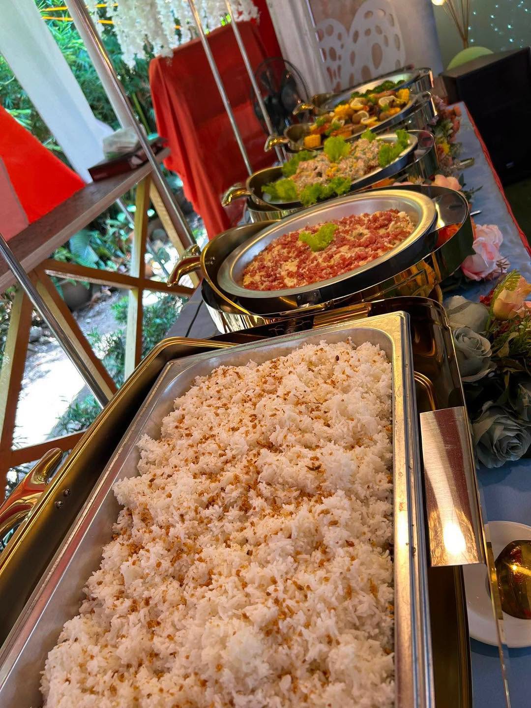 A buffet line of rice and catered dishes prepared by Pots and Buds Cactus Cafe