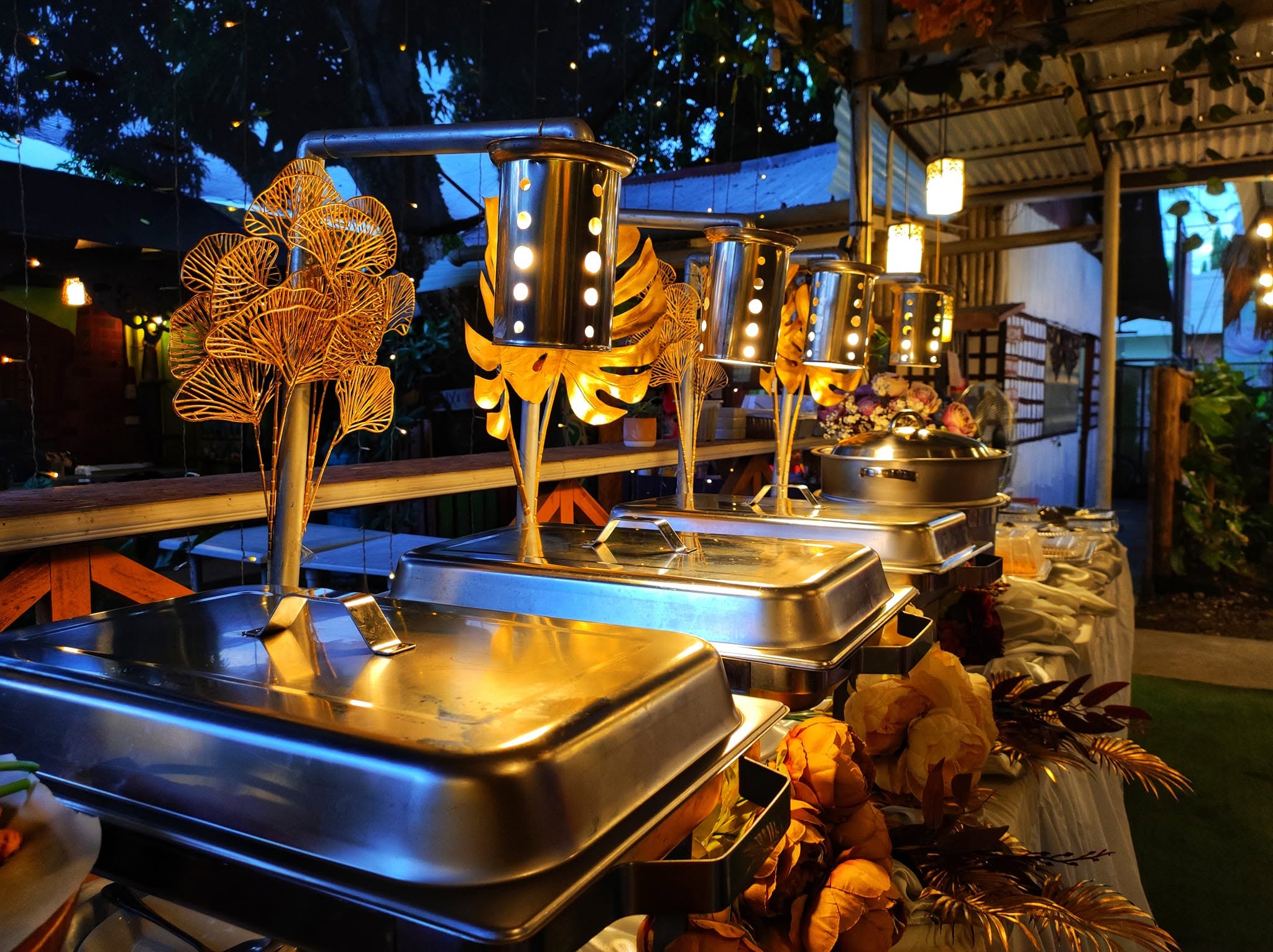 A catered food station with chafing dishes prepared by Pots and Buds Cactus Cafe