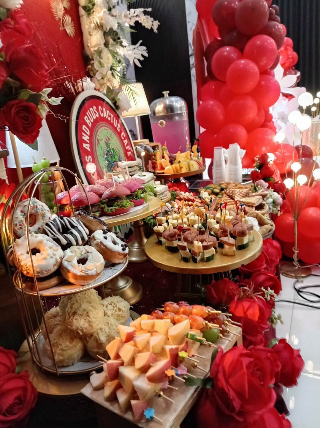 A colorful grazing table with fruit, bites, and desserts prepared by Pots and Buds Cactus Cafe
